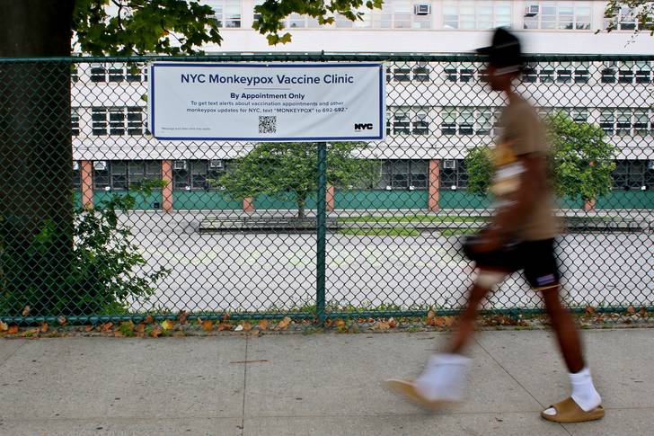 A man walks near a sign for a NYC monkeypox vaccine clinic in the Bronx on Aug. 2, 2022. The city is launching a new community-based initiative to close vaccine gaps.